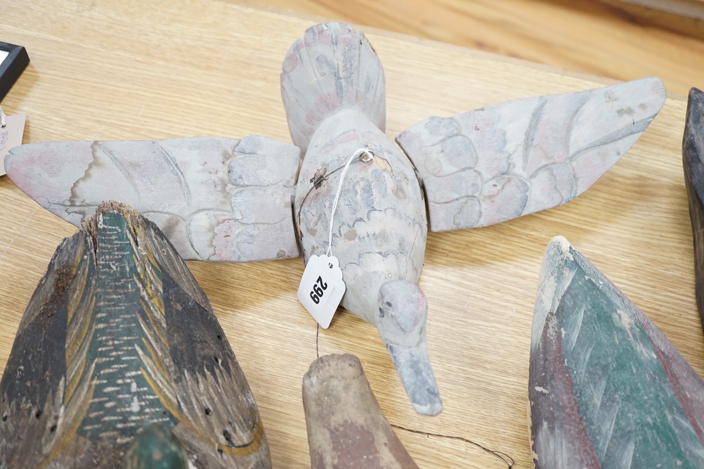 Five primitive wood decoy ducks, one in flight, longest 40cm